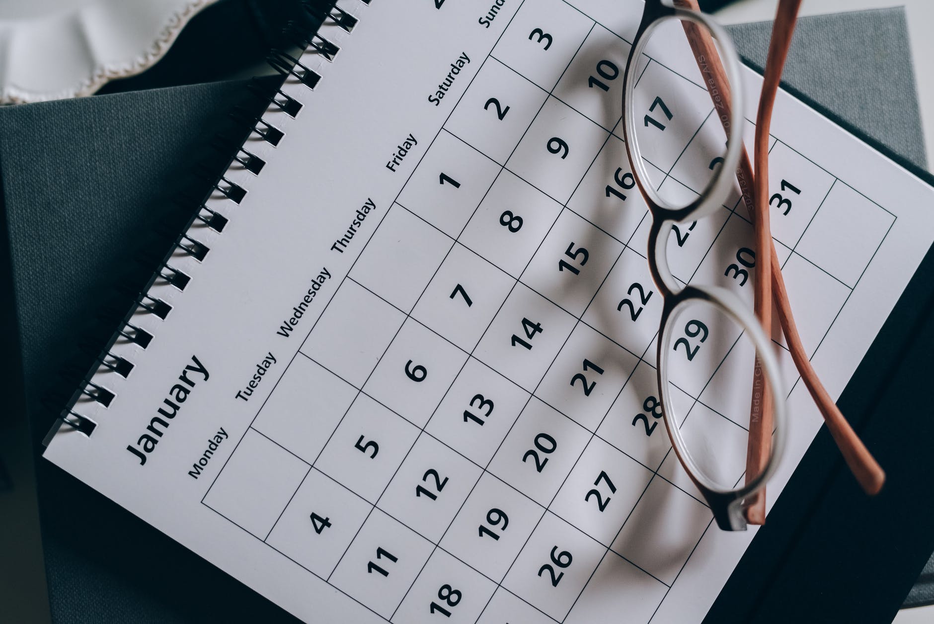 brown framed eyeglasses on a calendar